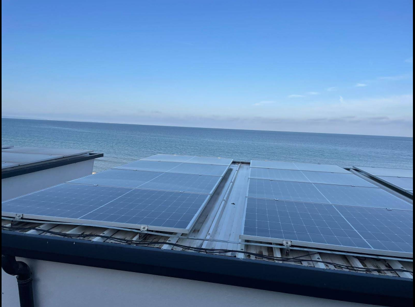 Professional solar cleaning company working on rooftop panels UK